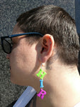 Alister wearing Hir Pronoun Earrings
