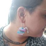 Alister wearing genderfluid juice box earrings